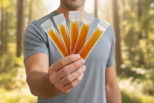 This scene showcases a hand-held collection of manuka honey sticks, hinting at the versatility and on-the-go accessibility of this nutritional supplement.